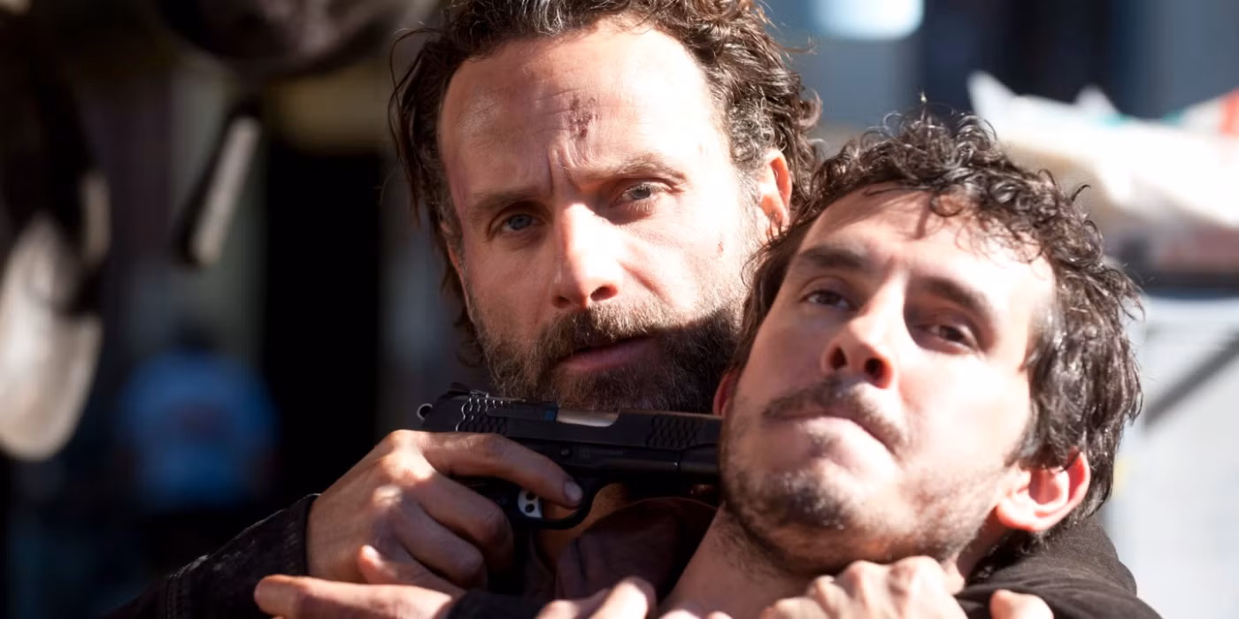 Rick Grimes with a gun to someone’s head in The Walking Dead